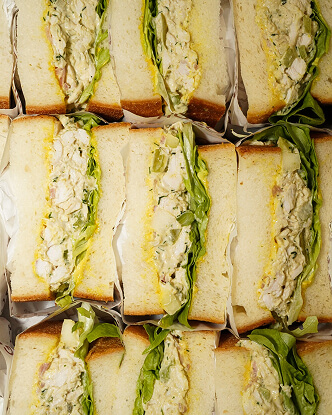 Stacked sandwiches filled with lettuce and egg salad