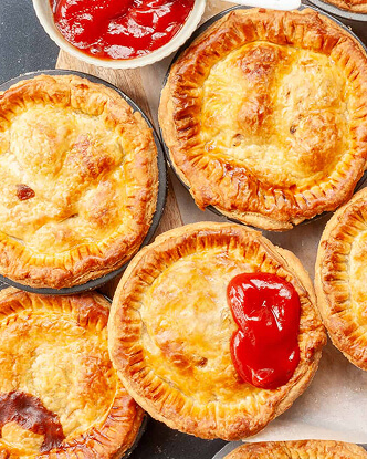 Assorted golden pies served with tomato sauce
